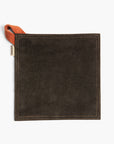 Black suede leather hot pad with a Terracotta hanging strap on a white background
