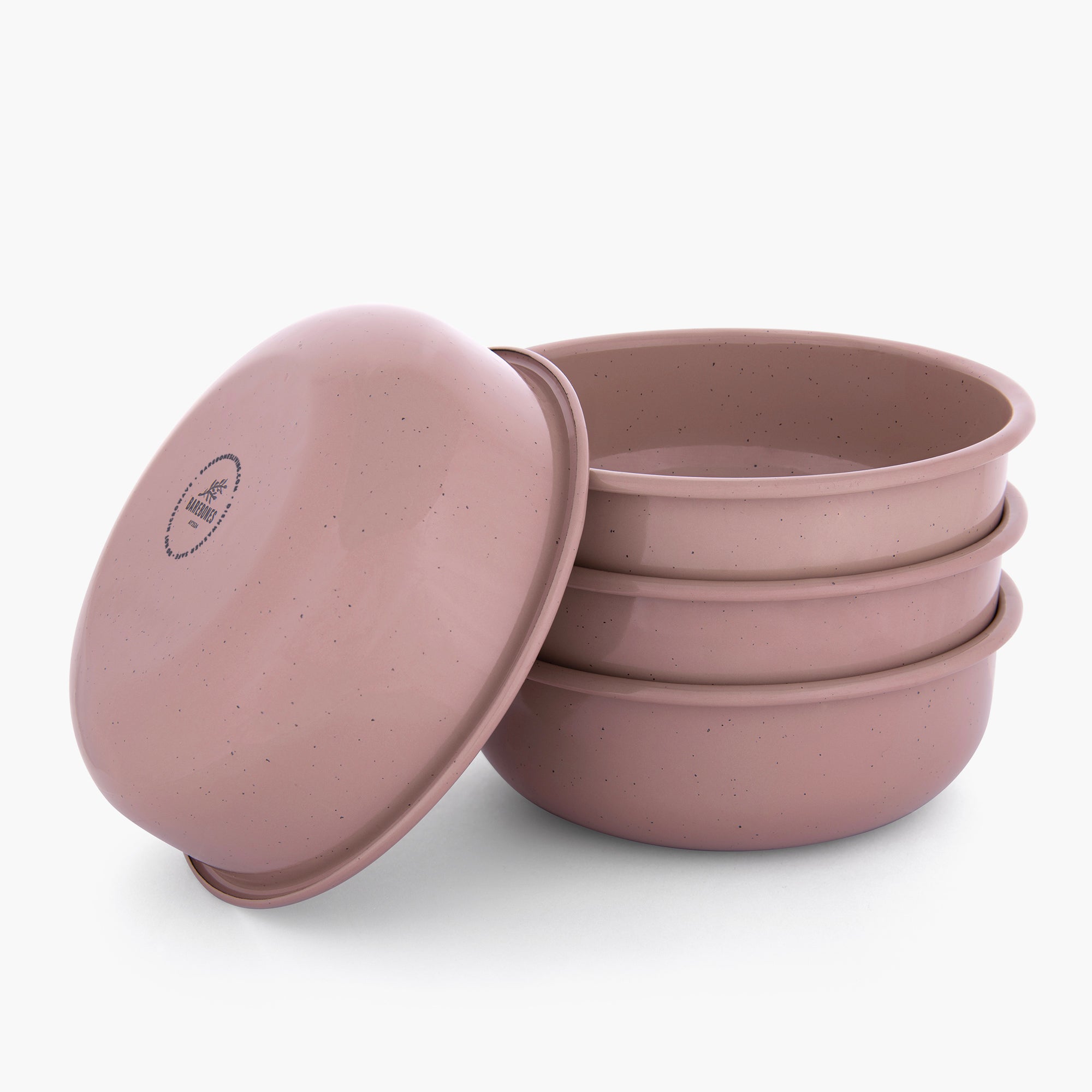 Set of four dusty rose rolled enamel bowls on a white background