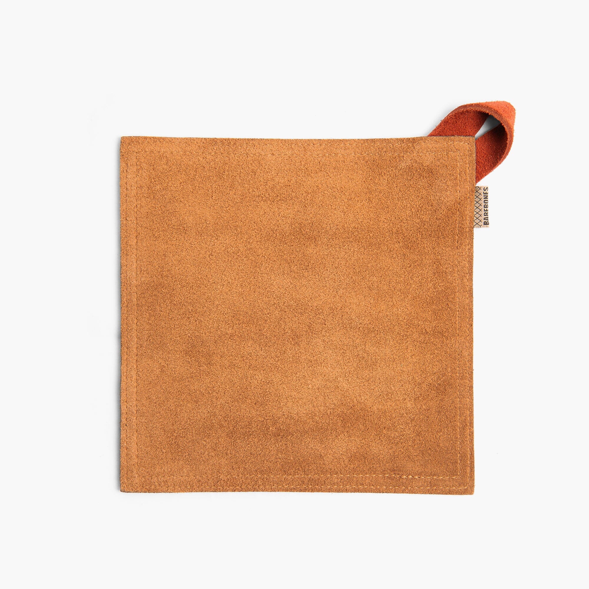 Tan suede leather hot pad with a Terracotta hanging strap on a white background
