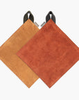 Two suede pot holders, one Tan and one Terracotta, on a white background.